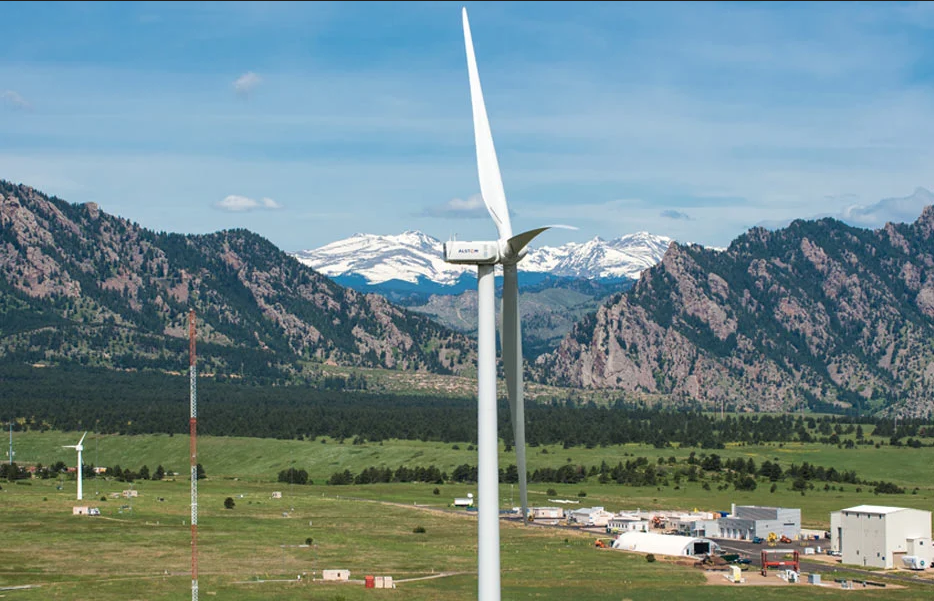 Mountains near Boulder, Colorao, with several wind turbines depicted.