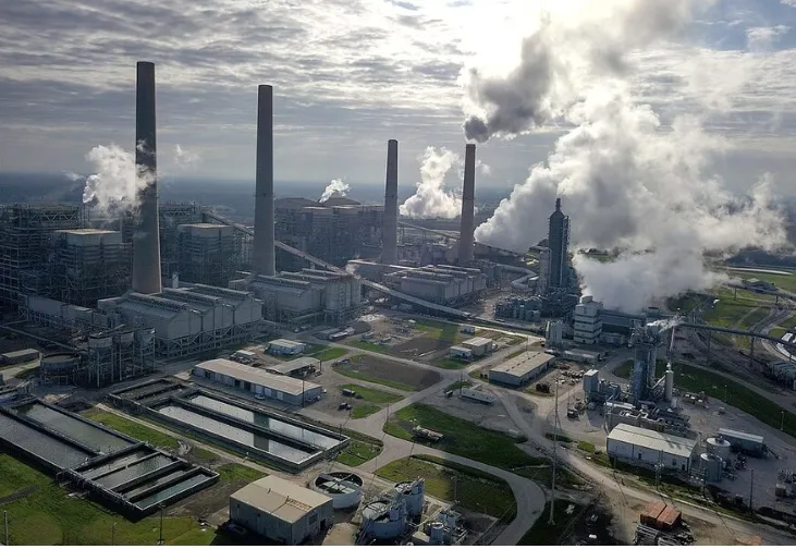 Lots of smokestacks at power plant.