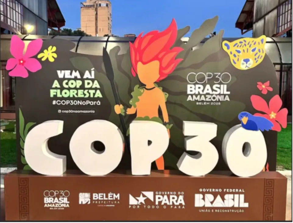 A billboard sign announcing with flashy graphics the COP30 climate summit.